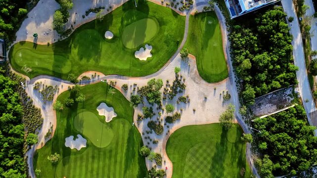 Aerial top down view of luxury golf course at sunset