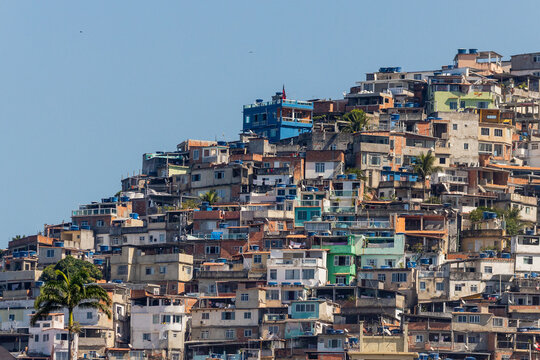 Colorful urban slum architecture in a Brazilian favela on a steep hill with clear blue sky