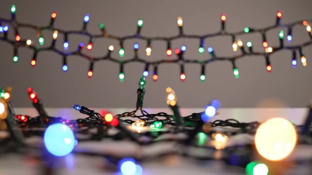 Colorful decorative string lights glow against a soft neutral background