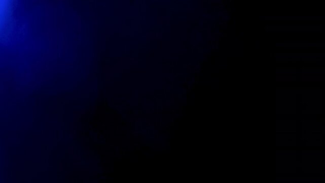 Colorful flare texture spreads across a dark backdrop, creating a glowing overlay element for video editing and visual effects with editable overlay use and dark studio contrast.