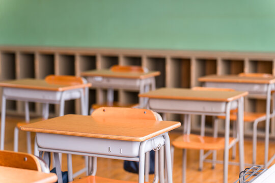 Image of a classroom/school building with a blackboard (with lockers)