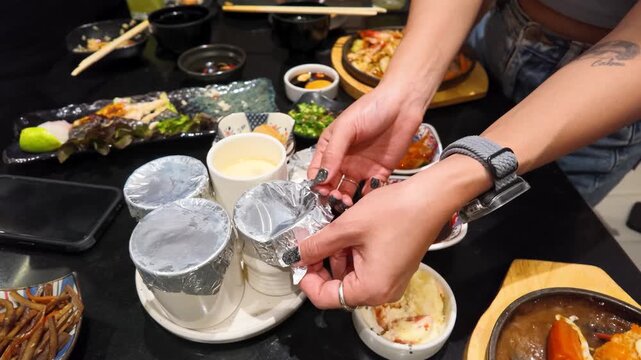 Person Uncovering Steamed Egg Custard Chawanmushi at a Restaurant