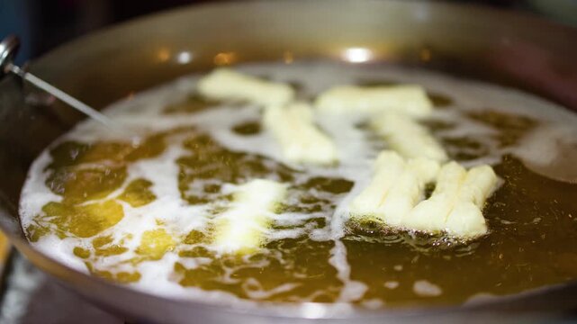 Chef Deep Frying Chinese Doughnuts Youtiao in Hot Oil Wok