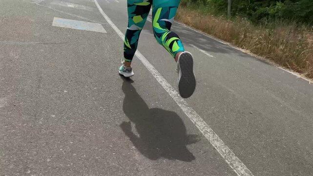 Running along open path in lush surroundings. Active lifestyle and connection with nature concept. Invigorating fresh air and energy invigorate every stride