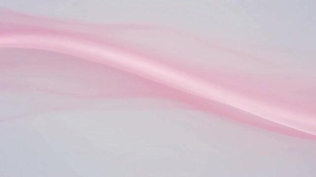 Smooth flowing pink ribbon against a soft white background