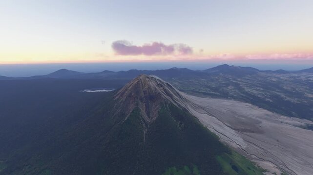 Circular aerial drone view at sunset of Mount Sinabung in Karo Regency. North Sumatra. Indonesia