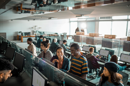 Diverse students collaborating on computers in modern university lab