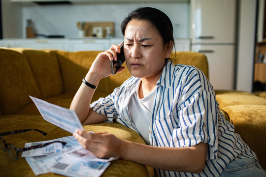 Concerned woman calling about bills at home