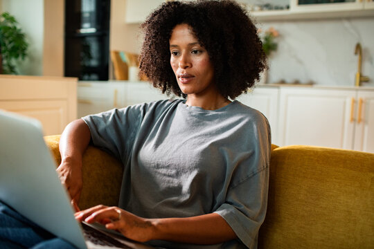 Young woman working on laptop at home