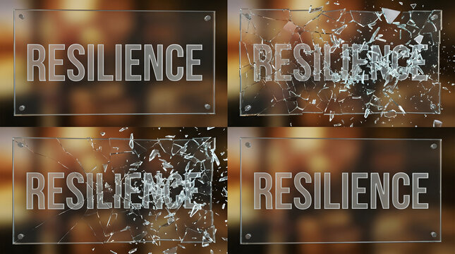 Glass plaque with resilience text breaking into shards and reforming against warm bokeh light.