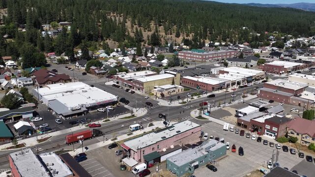 Aerial of downtown Cle Elum Washington with commercial buildings and forest with town center in summer