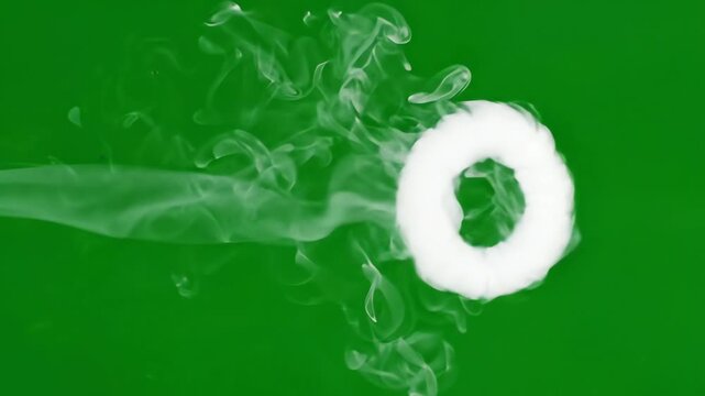 Perfect white smoke ring drifting slowly across a solid chroma key green screen background