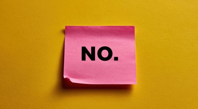 Pink sticky note with the word no printed in bold black letters on a bright yellow