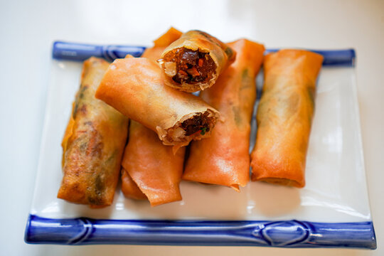 Homemade vegetarian spring rolls served on ceramic plate ready to eat