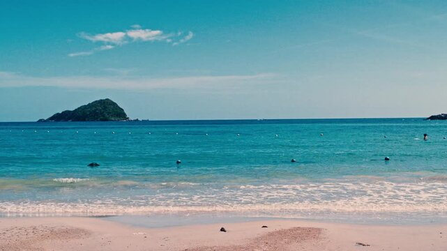 Scenic view of tropical sea shoreline with sandy beach under blue sky.