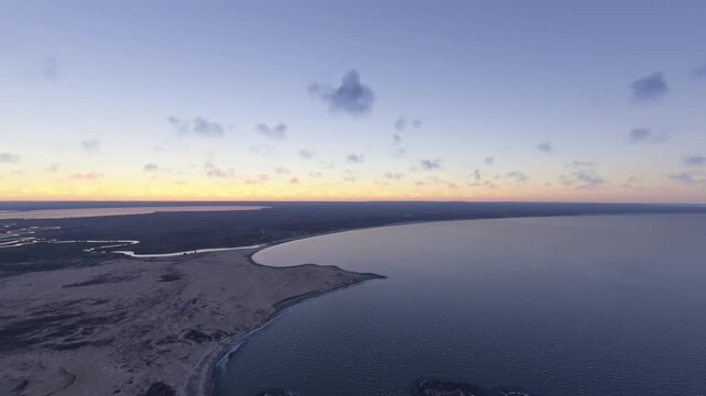 Circular aerial drone shot at sunset of Barra de Valizas in Rocha Department. Uruguay