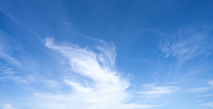 Blue sky and white cirrocumulus clouds texture background. Blue sky on sunny day. Summer sky. Cloud formation. Fluffy clouds. Nice weather in summer season. Weather pattern. Atmospheric phenomenon.