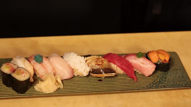 Chef Arranging Fresh Sushi Platter with Nigiri and Ginger