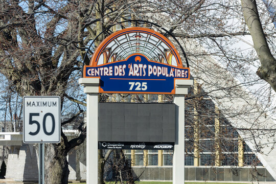 Quebec, Canada, 24 April 2026 : A sign for the Center for Popular Arts with address  stands next to a speed limit sign.