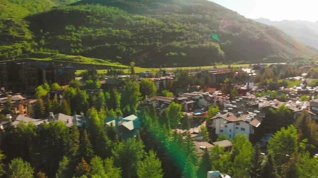 Aerial view of vail village resort during summer with green mountains and luxury alpine architecture in colorado valley.