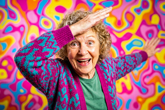 Happy grandmother performing dab dance pose on psychedelic background