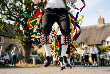 Fototapeta premium Morris dancer jumping with bells and ribbons at english festival