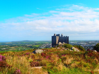 Historic stone castle on rocky hill overlooking fields and town © Tib