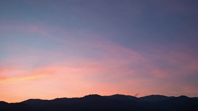 Evening sky time-lapse capturing the shift from sunset glow to night time darkness with subtle cloud movement.