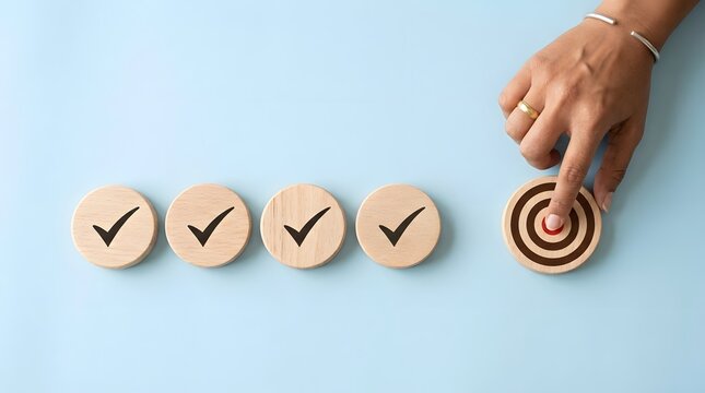 A hand placing a final target marker beside four completed checkmark icons