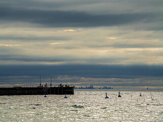 Obraz premium Cold Winter Pier With Distant City Views