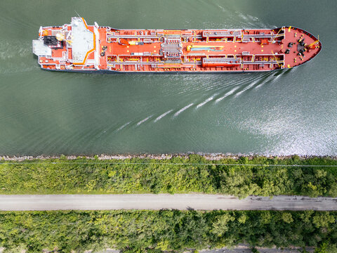 Aerial top view of oil tanker cargo ship navigating the St Lawrence River near Montreal, Canada. g.
