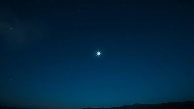 Single bright star in a deep blue night sky.