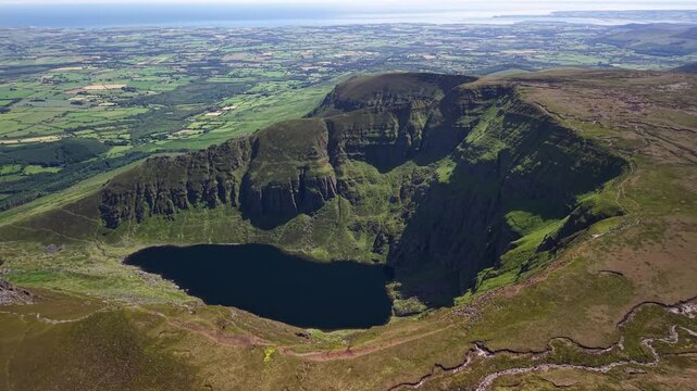 Breathtaking drone panorama of Coumshingaun Lake and dramatic cliffs, Ireland