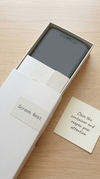 Matte white smartphone in an open box, promoting Digital Detox and mindful screen time