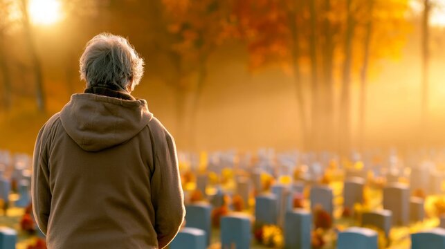 Elderly Person Reflecting in a Serene Cemetery During Autumn, Golden Hour with Soft Sunlight
