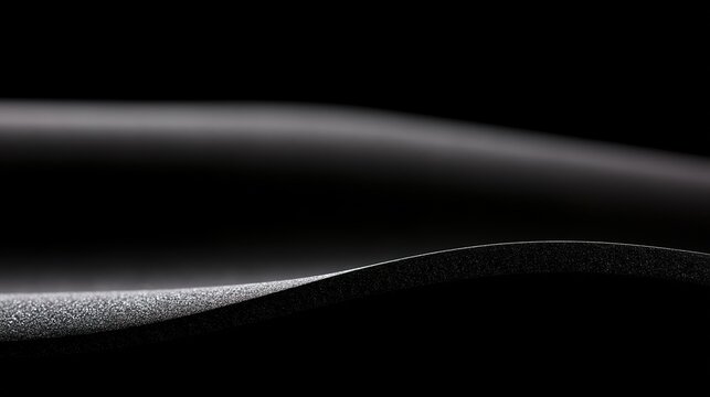 Tense black synthetic rubber curve with highlights, abstract interaction of material and studio light