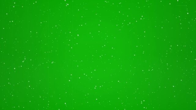 Falling snow particles over a vibrant green screen background, perfect for winter scenes or compositing effects