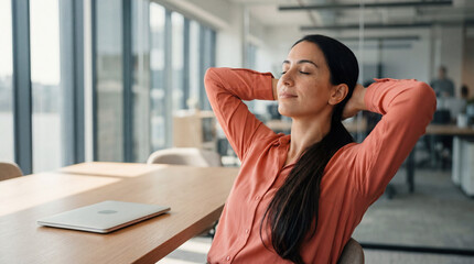 Fototapeta premium Woman stretching at office desk with laptop relaxing after work break wellness concept