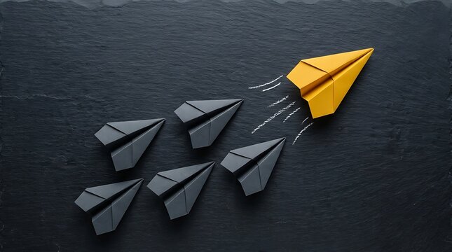 Paper airplanes on a slate background representing leadership and standing out from the crowd