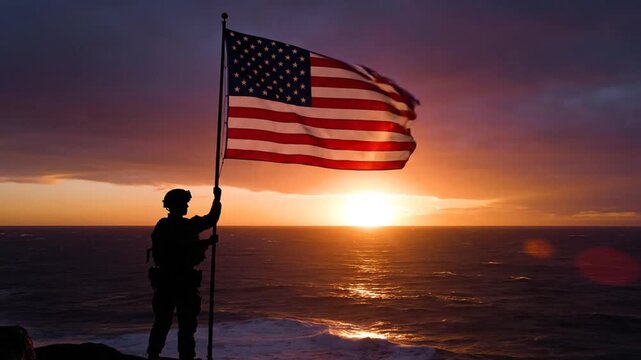 Soldier holding American flag at sunset overlooking the ocean