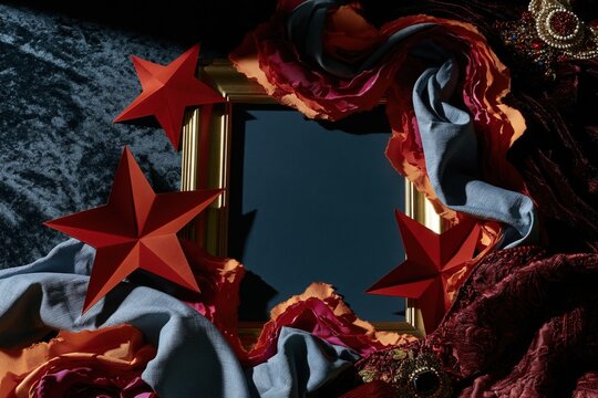 Empty picture frame mockup surrounded by paper stars and velvet fabric with copy space for a festive Juneteenth greeting or Juneteenth celebration