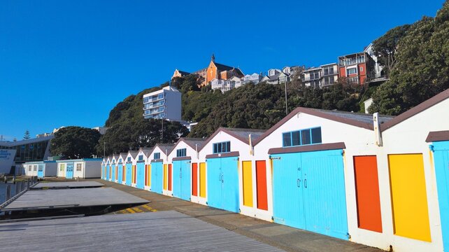 Scenic view iconic boat sheds, houses, and church on hill in capital city of Wellington, New Zealand Aotearoa