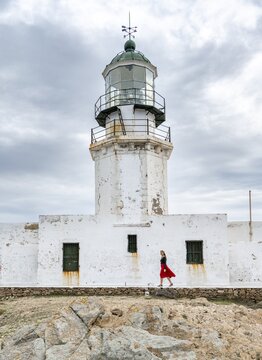Tourist with red skirt, Old Lighthouse, Faro De Armenistis, Mykonos, Cyclades, Aegean Sea, Greece