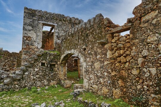 Historic ruins with window openings and a vault, surrounded by green vegetation, sky replaced, Aradena Gorge, Aradena, Sfakia, Crete, Greece