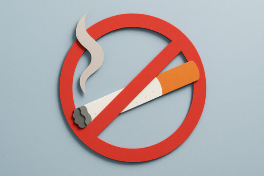 Paper cut no smoking sign with red prohibition circle and cigarette on light blue background
