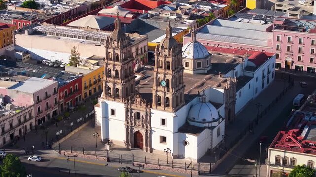 A graceful high-angle aerial drone reveal highlighting the intricate colonial-era architectural detail of the Cathedral Basilica of Durango.