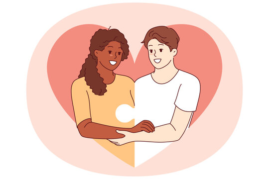 Love between diverse couple and with man and woman holding hands and consisting of puzzle pieces. Multiracial love or romantic relationships through mutual understanding or equality