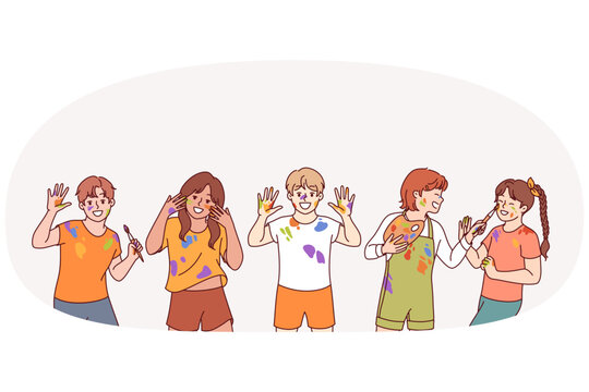 Little artist children with paint stains on hands and clothes rejoice at opportunity to develop creativity. Boys and girls artists from kindergarten laugh after lesson on drawing and creative