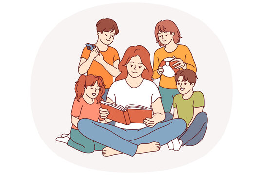 Woman kindergarten teacher reads book to children who are listening with interest to new fairy tale. Happy kindergarten students enjoying friendly atmosphere and opportunity to spend time together