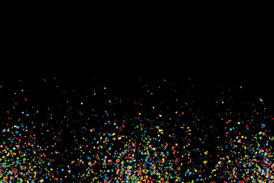  Colorful bright confetti burst on black background for night party and anniversary celebration